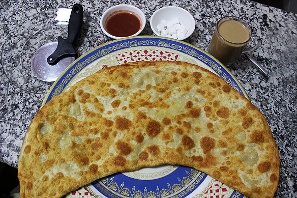 Bolani, Afghanistan's version of a stuffed paratha, is a deep-fried half-moon-shaped flatbread filled with potatoes or meat.