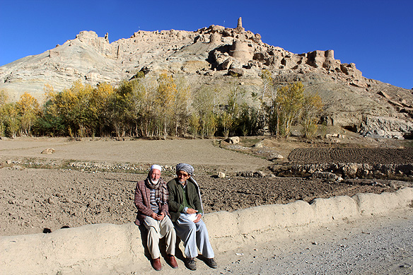Two old Hazara friends and the ruins of Shahr-e Gholghola in the background.