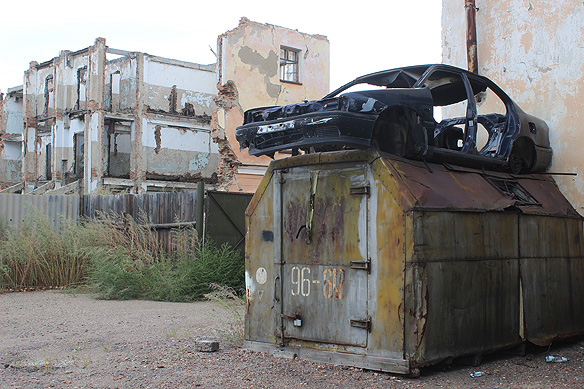 I did not know what to make of this. Like, how did that car land up on the roof of the shed. And why??