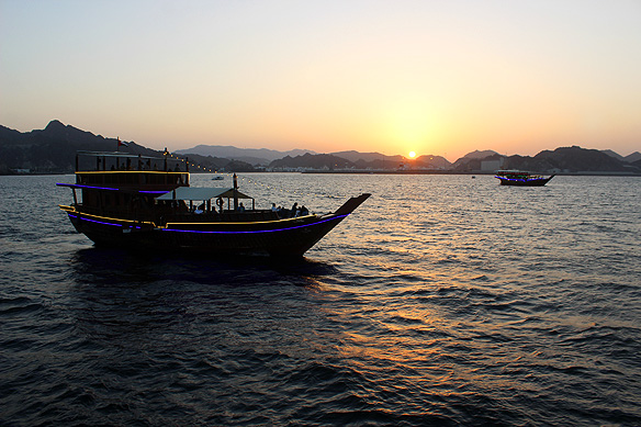 Dhows from Muttrah plough the waters of the Sea of Oman at sunset: a mandatory Muscat experience.