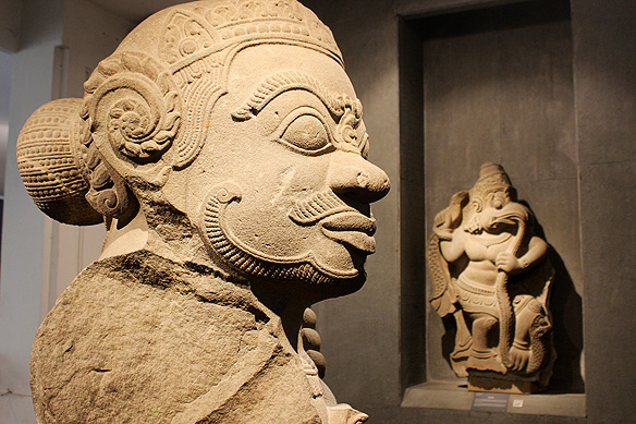 Dvarapala, the temple guardian, with a Garuda devouring a Naga [snake] in the background, 12th Century, Sandstone, Thap Mam.