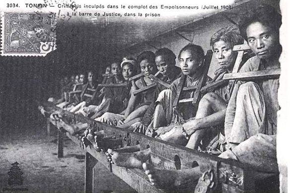 Revolutionaries behind the 1908 Hanoi Poison Plot detained at the Hoa Lo Prison by the French colonists. 13 of them had their heads chopped off instantly and displayed in public. The French later used the photo for an Indochina postcard.