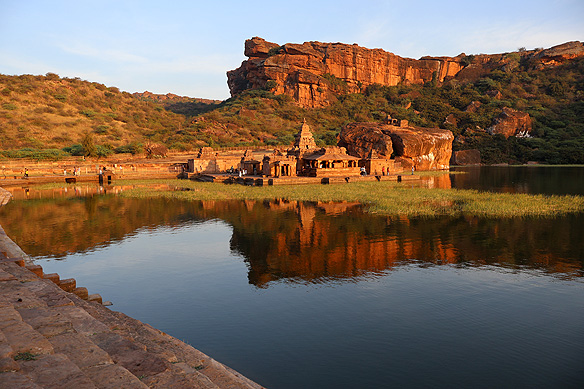 Sunset on the steps of the 7th Century Agastya Teerth with the Bhoothnath temple complex and Badami Caves escarpment in the background. A view that has not changed over the past millennium and a half.
