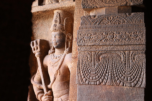 Shaiva-Dvarapala with a trishul [trident] on the left extension of Cave 1's porch entrance.