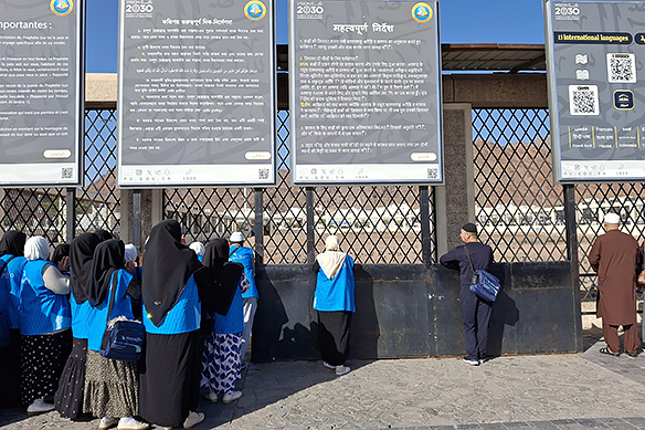 Signboards in multiple languages [French, Bangla, and Hindi in this image] outline guidelines for visiting the Martyrs' Cemetery as per Wahabism.