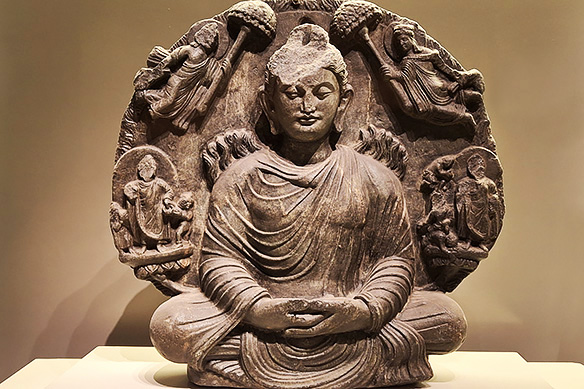 In the Miracle of Sravasti, Buddha radiates flames from his body symbolizing divine power. 2nd Century CE, Kabul [North-West part of Undivided India].