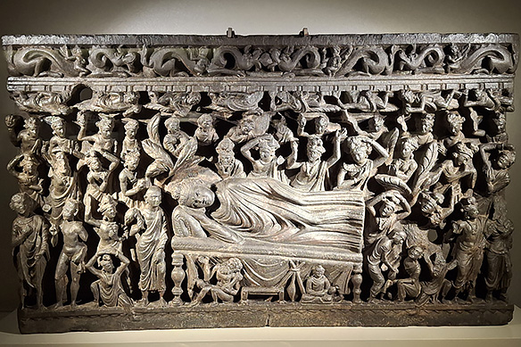Schist relief panel showing the scene of the Mahaparinirvana—the Buddha's final passing and liberation from the cycle of rebirth. 2nd Century CE, Loriyan Tangai [North-West part of Undivided India].