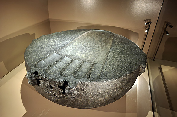 This black stone Buddhapada, or Footprint of the Buddha, is carved beneath the dome of a votive stupa. It features a socket for the insertion of the umbrella finial. 11th Century CE, Bodhgaya, Bihar.
