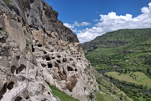 12th Century Vardzia, when built on the orders of King Tamar, was fully encased in the sandstone mountains. An earthquake in 1283 ripped it open.